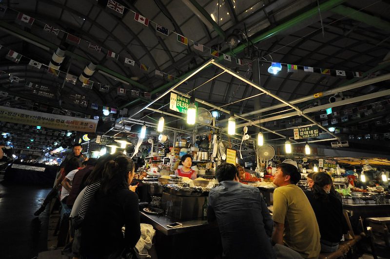 Late night snackers gather around for some sundae (blood sausage) and bindeddeok (mung bean pancake with vegetables and meat).